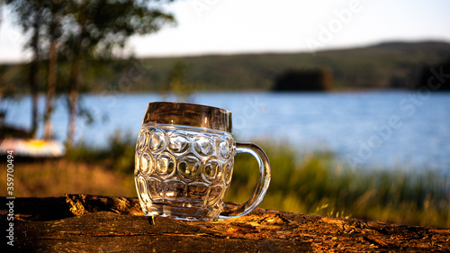 The midnight sun shines on an empty beer jug. Photo was taken on midsummer's day next to the lake Siljan in Sweden.