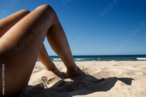 Nice girl with a green bikini having fun on the beach
