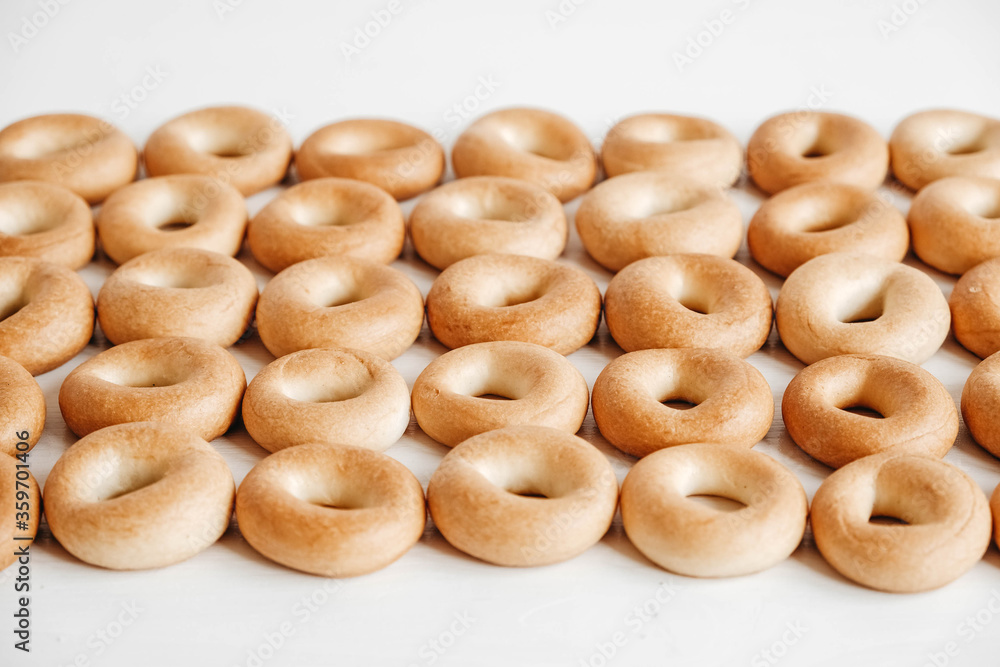 Drying or mini round bagels on a white wooden background. Top view. Copy, empty space for text Drying or mini round bagels on a white wooden background. Top view. Copy, empty space for text