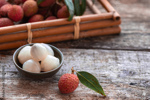 Lychee with leaves on gray background. Tropical fruit. photo