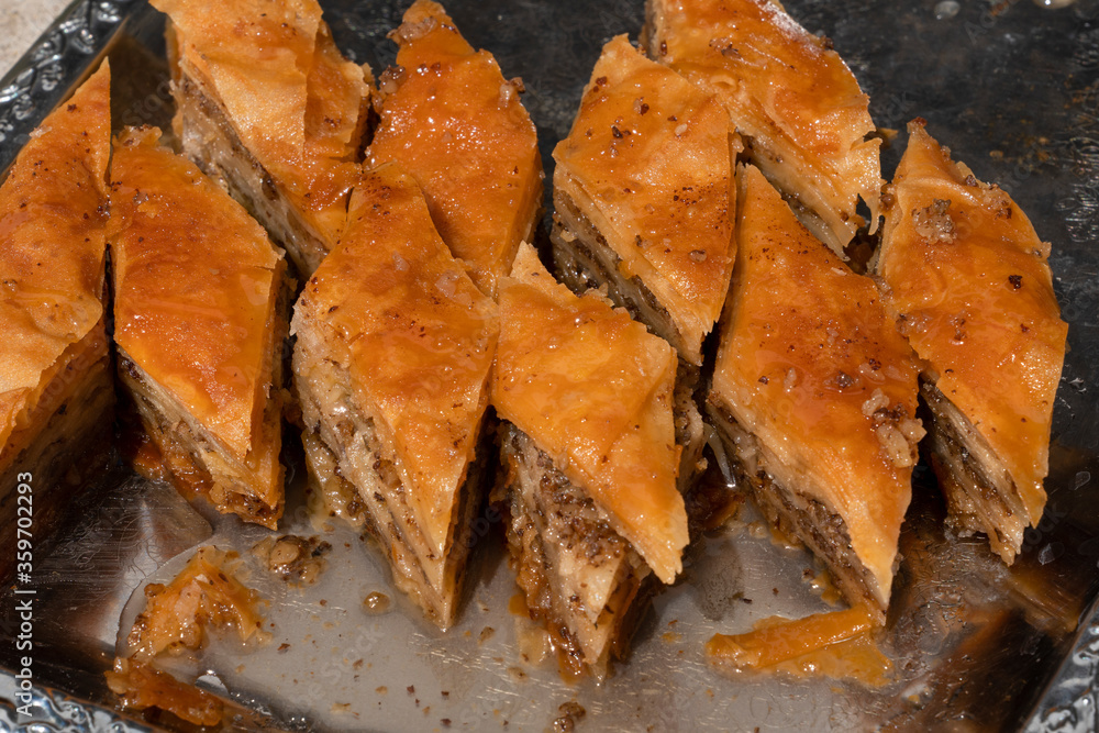Diamond shape homemade Turkish baklava. Baklava in a metal tray. Baklava with walnut. (Cevizli baklava in Turkish) Diamond shape homemade Turkish baklava. Baklava in a metal tray. Baklava with walnut. (Cevizli baklava in Turkish)