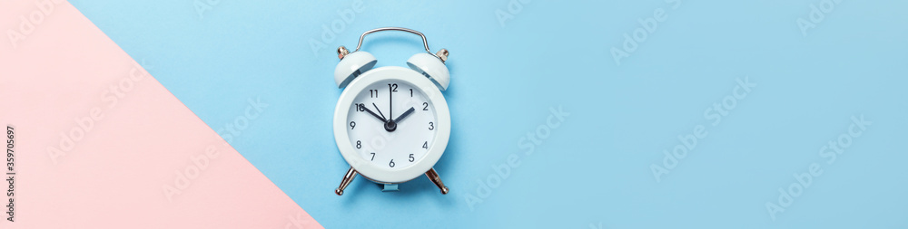 Simply minimal design ringing twin bell classic alarm clock Isolated on blue pink pastel background. Rest time of life good morning night wake up awake concept. Flat lay top view copy space banner Simply minimal design ringing twin bell classic alarm clock Isolated on blue pink pastel background. Rest time of life good morning night wake up awake concept. Flat lay top view copy space banner