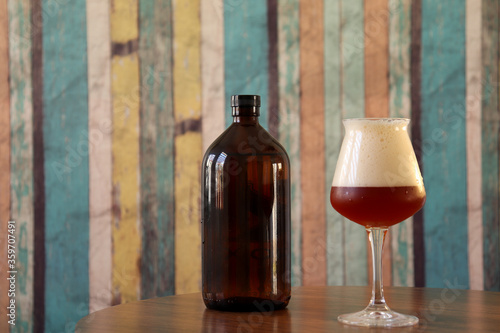 Craft beer amber ale in teku glass with growler