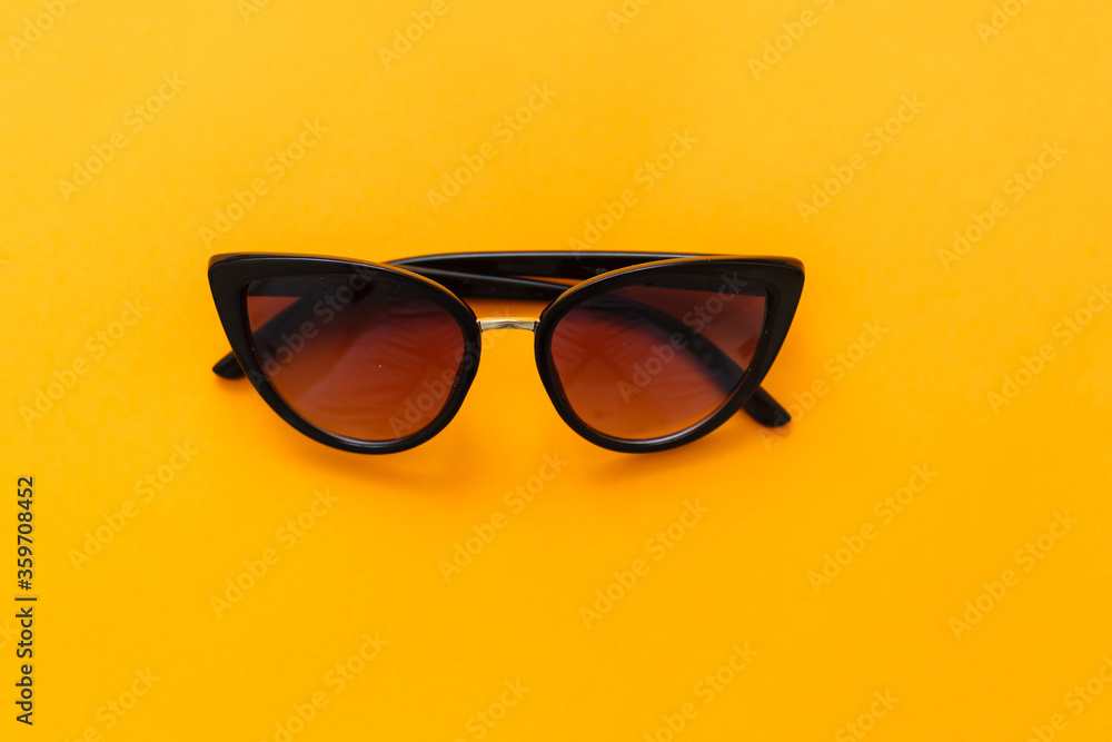 Yellow sun glasses isolated over the yellow background Yellow sun glasses isolated over the yellow background