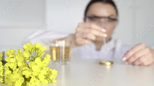 Young girl scientist studies rapeseed oil in a laboratory photo