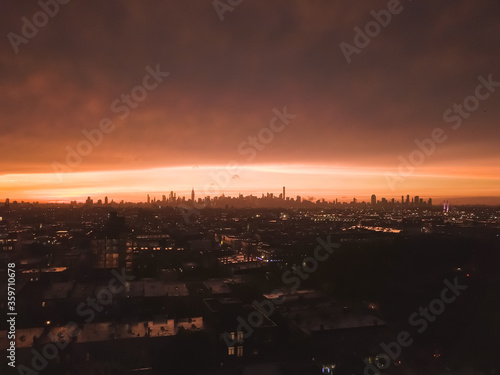 Wallpaper Mural Aerial View from Brooklyn over far away Manhattan Skyline in the Distance after Sunset with Fire Red Light and Skyscraper Silhouette  Torontodigital.ca