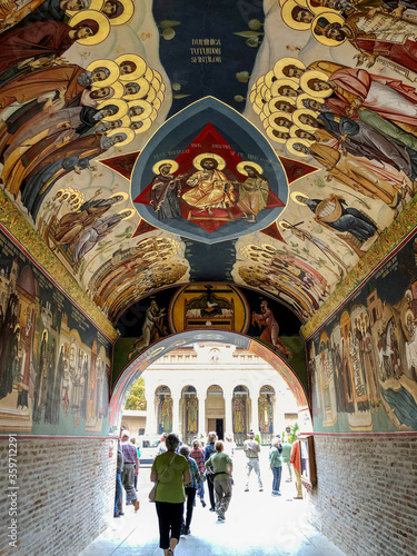 people walking through church passageway in Bucharest Romania