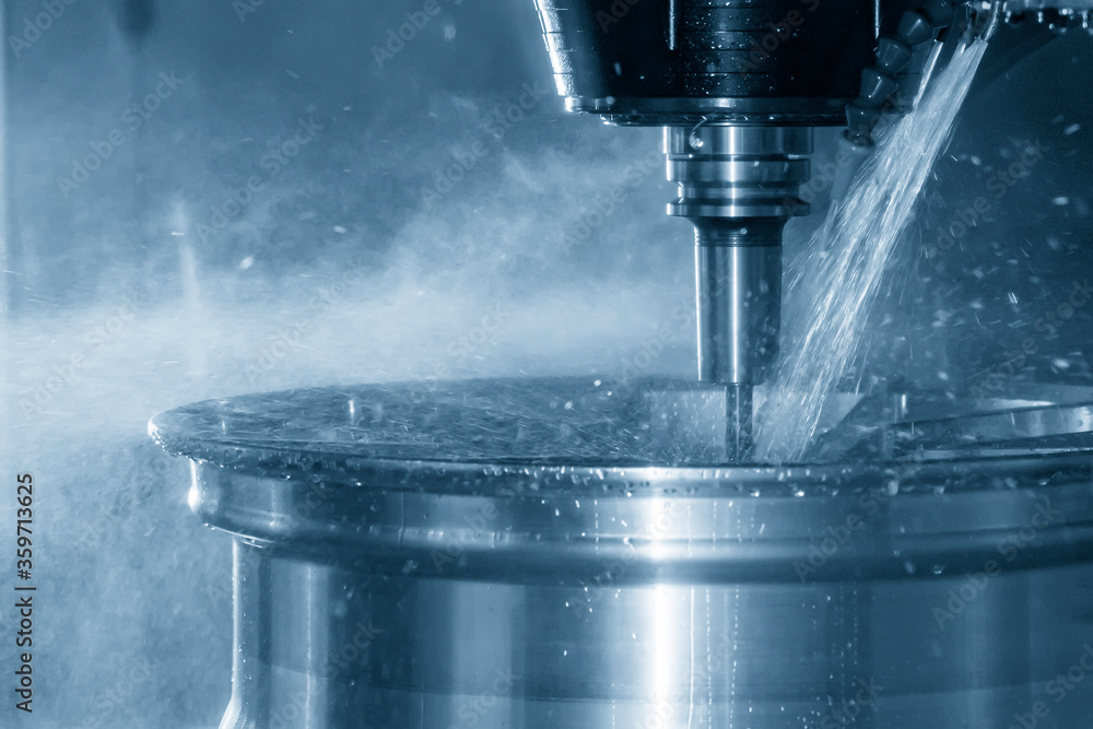 The multi-axis machining center cutting the magnesium alloy wheel by solid end mill tools. The hi-technology automotive parts manufacturing process by CNC milling machine. The multi-axis machining center cutting the magnesium alloy wheel by solid end mill tools. The hi-technology automotive parts manufacturing process by CNC milling machine.