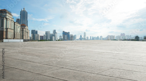 Fototapeta Naklejka Na Ścianę i Meble -  Wide empty concrete floor with  cityscape view