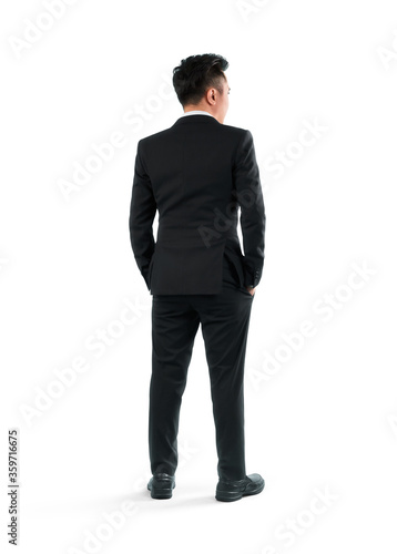 Young businessman rear view, full length portrait isolated on white background.