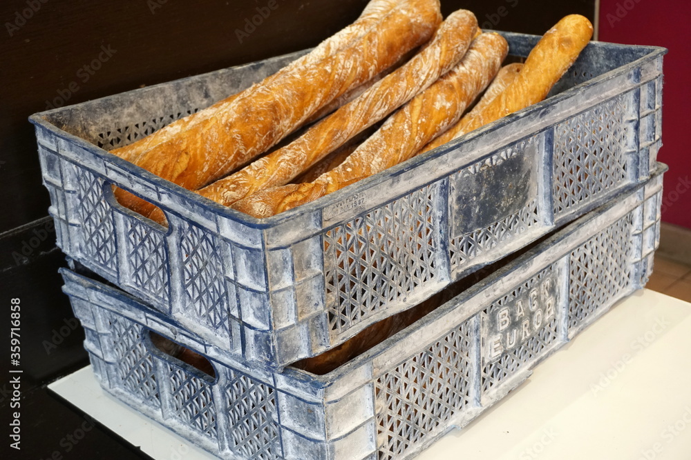 Traditional crusty French baguettes bread in a bakery shop. French bakery concept. Freshly baked baguettes.