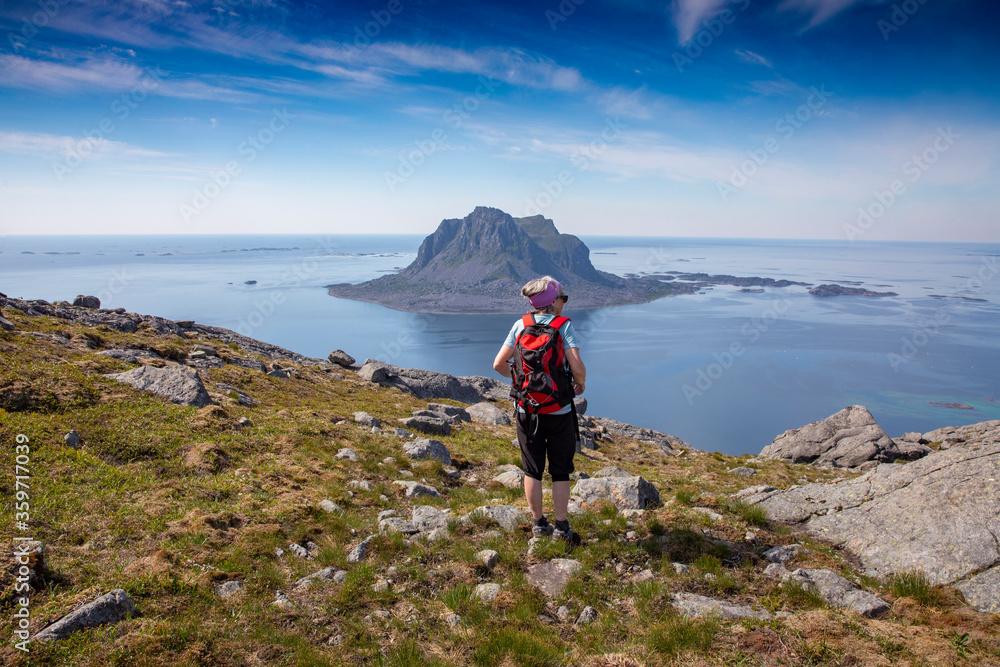 Woman hike to the Ravnfloget ,via the Vega stairs in Nordland county on a very nice summer day