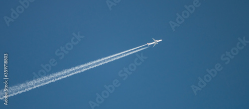 Photography jet airplane in the blue sky with trailing smoke