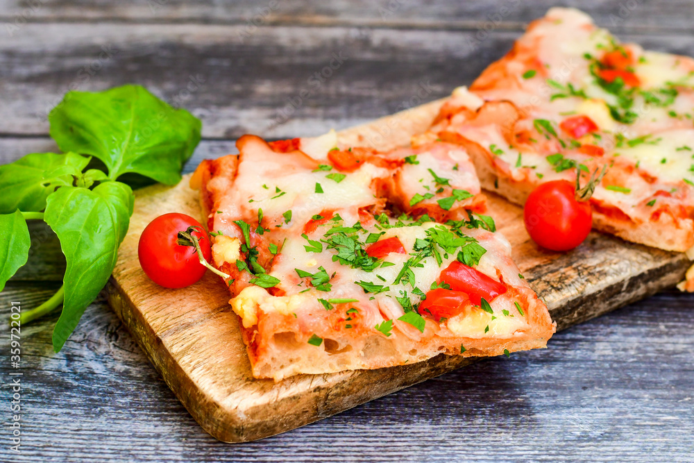 Assorted sliced italian roman style pizza. with parmesan cheese, ham, mushrooms and tomato sauce Assorted sliced italian roman style pizza. with parmesan cheese, ham, mushrooms and tomato sauce