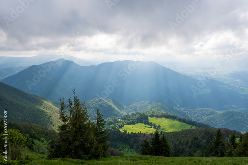 Green meadow in mountain and blue cloud sky. Composition of nature. Spring meadow. Composition of nature. Slovakia