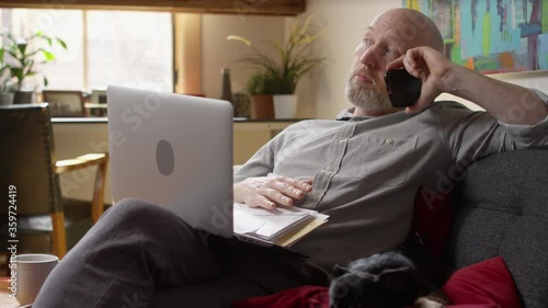 Man with a stack of bills piling up gets bored and antsy while waiting on hold