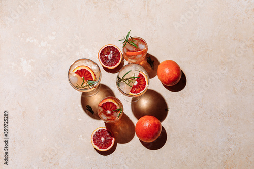 Summer cocktail with blood orange, grapefruit and rosemary