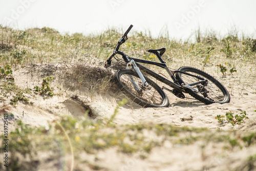 mountain bike posed in a path crossing the sand dunes