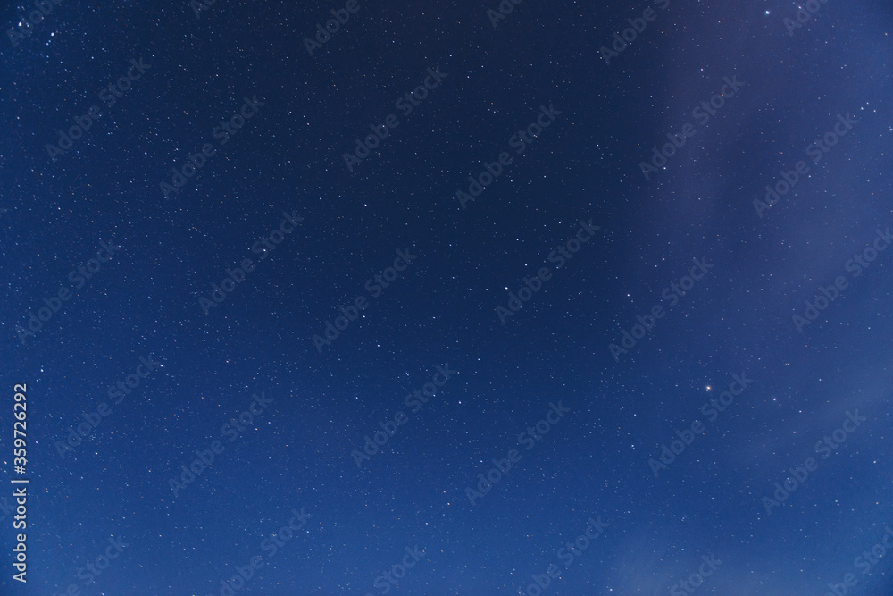 Naklejka premium Stars in the night sky with clouds, a beautiful astronomical background