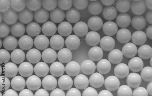 Closeup of white plastic bb s lined up on flat background