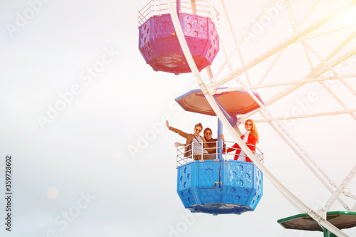 Photography Group of attractive young women having fun while they rotating on of colorful fe