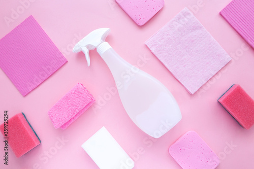 Detergents and cleaning products agent, sponges, napkins and rubber gloves, pink background. Top view