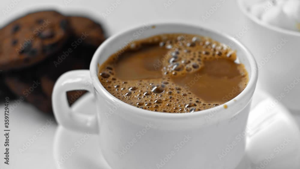 selective focus of bubbles in cup of coffee on white selective focus of bubbles in cup of coffee on white