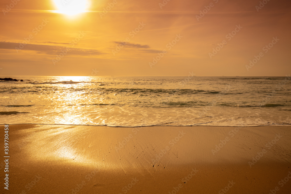 Seascape at sunset. Golden sunset over the sea. Beautiful beach in the evening