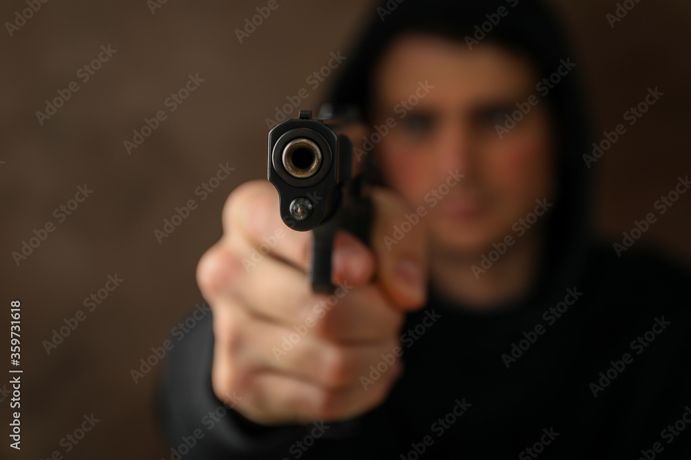 Man hold pistol. Selective focus. Robber. Violence Man hold pistol. Selective focus. Robber. Violence