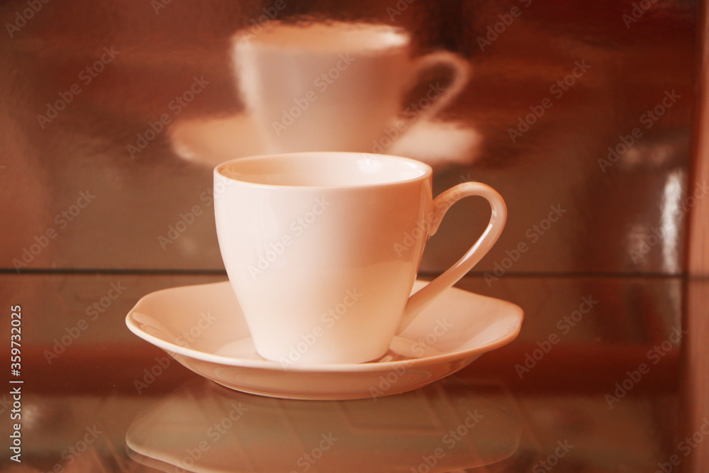White cup with coffee on a glass table. Background - mirror 3D reflection. White cup with coffee on a glass table. Background - mirror 3D reflection.