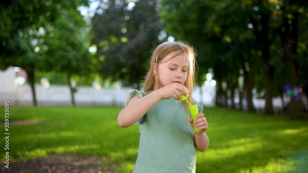 Pretty young girl blowing soap bubbles on a sunset Pretty young girl blowing soap bubbles on a sunset