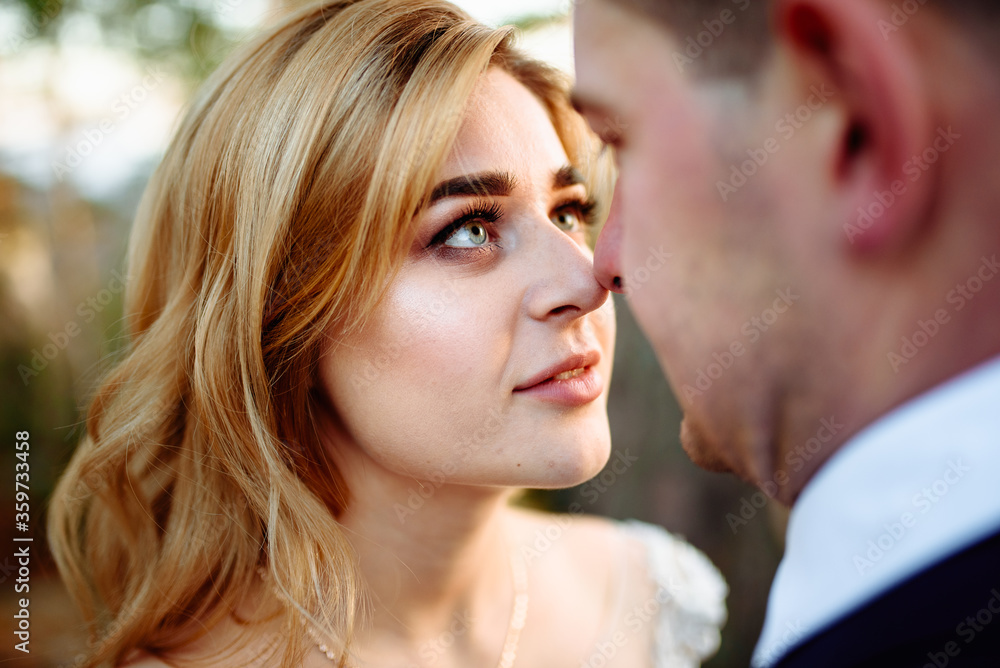 Fototapeta premium Bride and groom. Close-up. The bride looks at the groom.