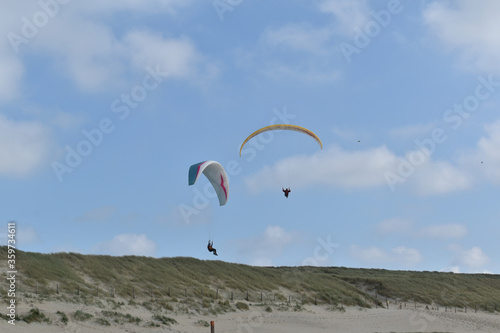 Paragliding at the beach of Katwijk aan Zee. Paraglider's making use of updraft of the dunes to stay in the air 