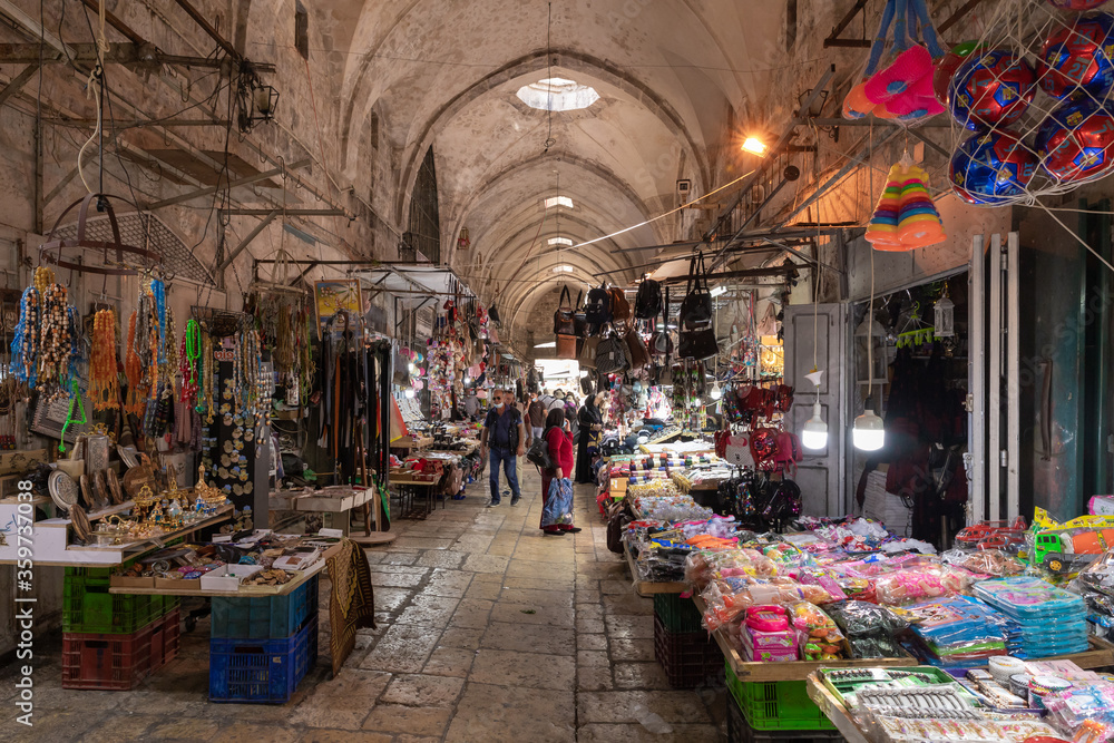 The Arab market with all kinds of souvenirs for tourists and locals on Al-Qattanin street in the Arab Quarter in the old city of Jerusalem, Israel