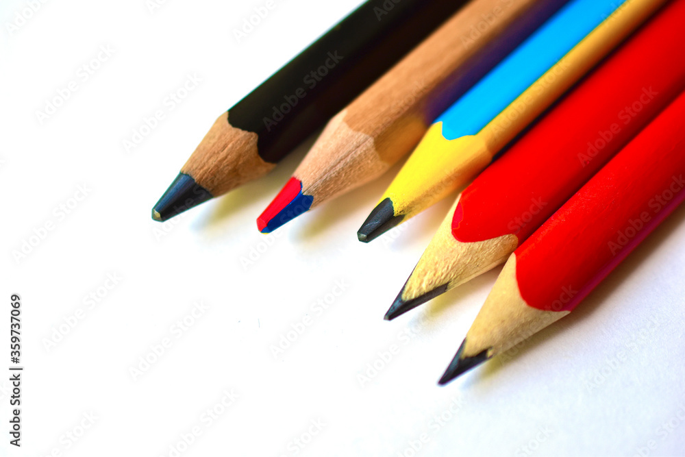 Multi-colored and large pencils on a white background Multi-colored and large pencils on a white background