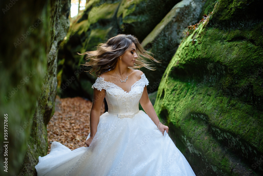 Portrait of a tanned bride in the gorge. The bride is spinning with happiness. Portrait of a tanned bride in the gorge. The bride is spinning with happiness.