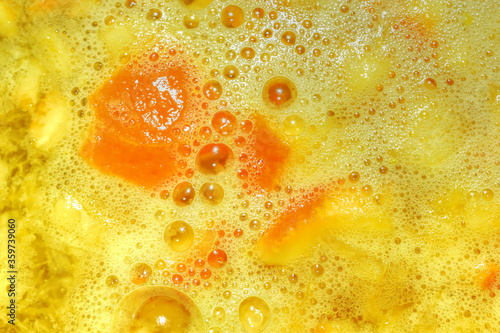abstract background of orange juice in early stages of preparation