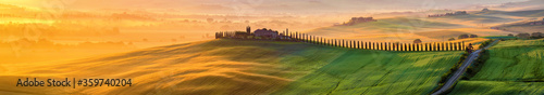 Tuscany landscape at sunrise. Typical for the region tuscan farm house, hills, vineyard. Italy photo