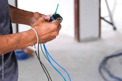 Cuadro en lienzo Electrician male working install wire power cable