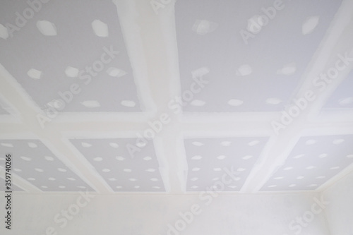 new house building install ceiling wall with white cement plaster smooth surface. inside room structure painter by craftsman.abstract multi dot effect background.