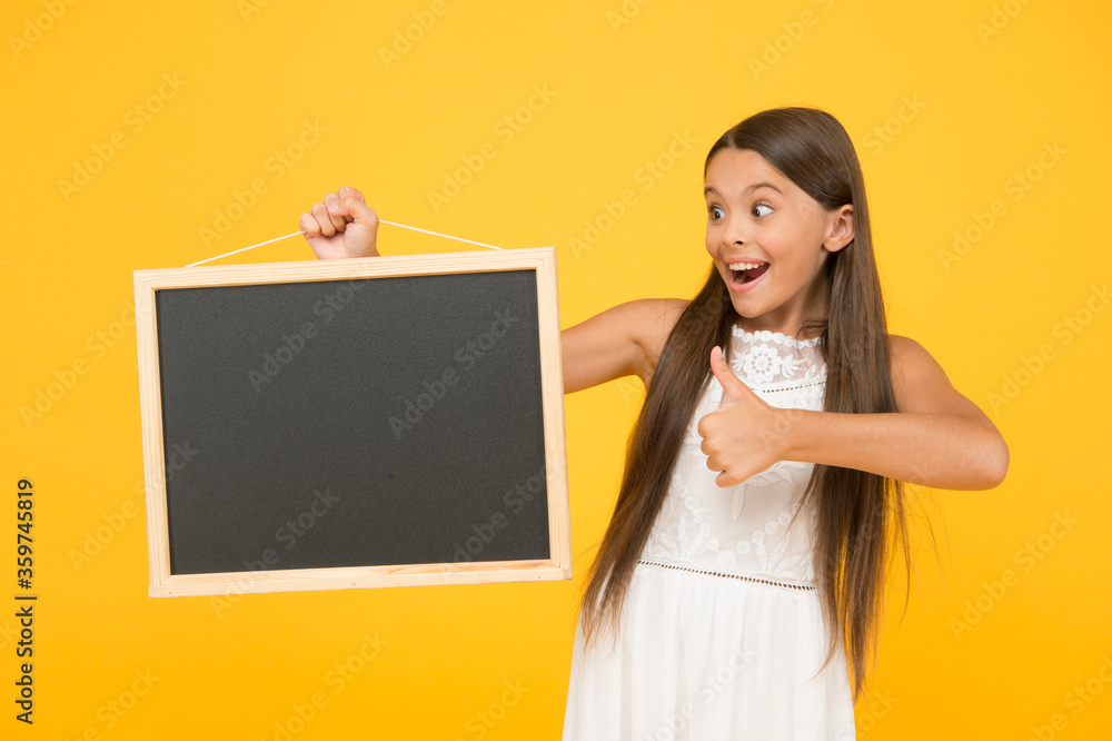 Small kid with blank blackboard. Advertisement promotion copy space. Good news for you. Chalkboard for information. Blank blackboard. Something you need to know. Happy smiling girl hold blackboard Small kid with blank blackboard. Advertisement promotion copy space. Good news for you. Chalkboard for information. Blank blackboard. Something you need to know. Happy smiling girl hold blackboard