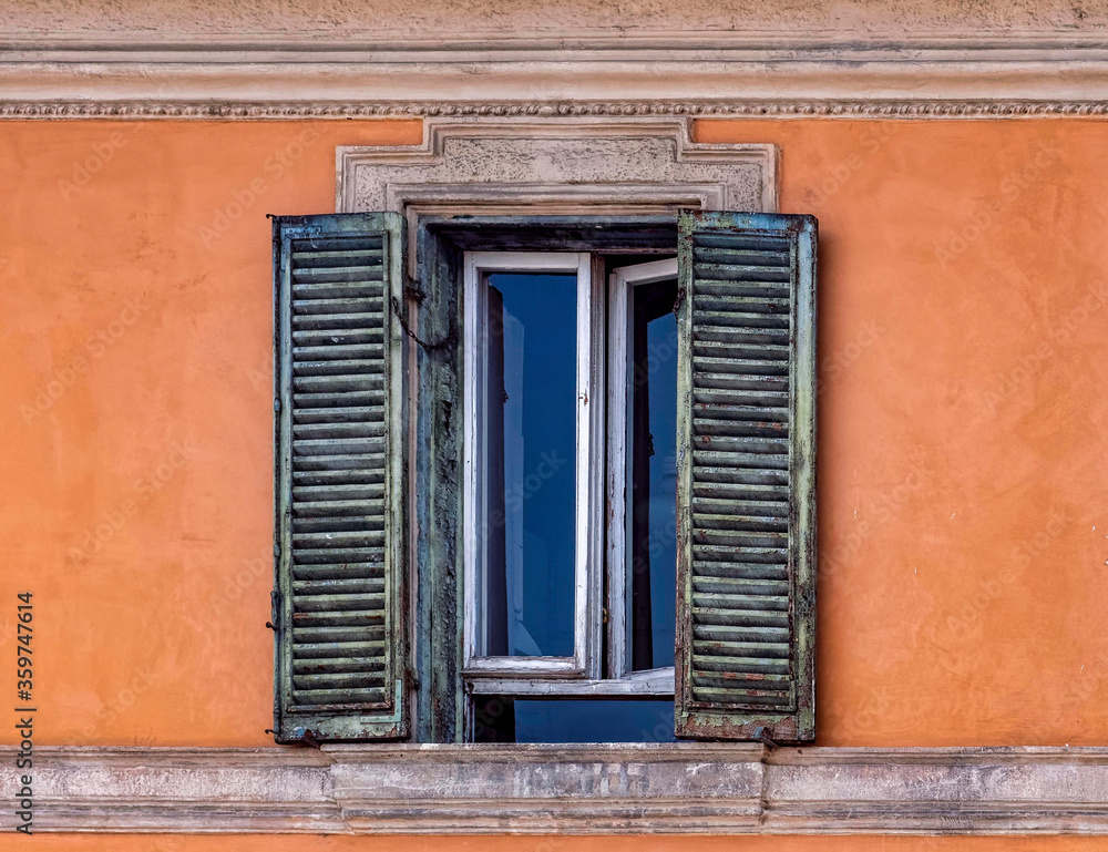 Rome Italy, vintage house decorated window on vibrant orange wall