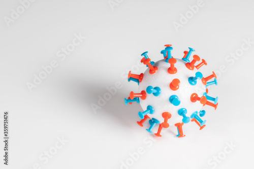 Coronavirus, sars-cov-2, or covid-19. Ball of polystyrene or expanded polystyrene with red and blue thumbtacks. Virus image design on white background