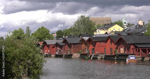 4K video of Porvoo vintage red wooden buildings, Porvoo Cathedral, yachts and boats in Porvoonjoki River near town center on sunny summer day in Finland, northern Europe photo