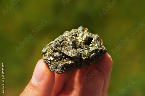 Pyrite or Fool's Gold from Perú held in a hand