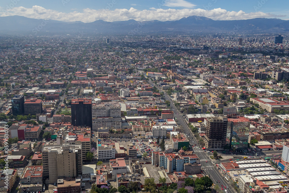 Aerial view of Mexico City center toward the south, with a mountain range in the back