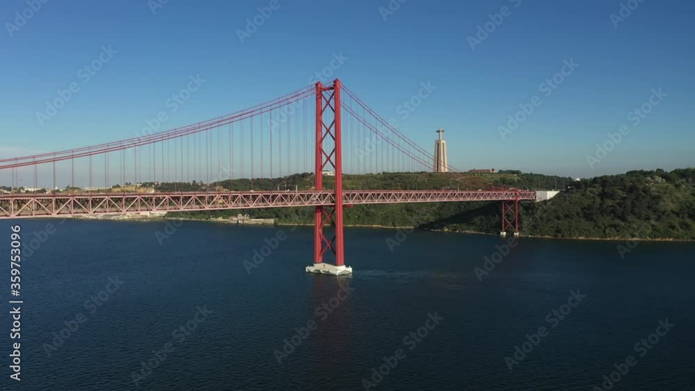 Aerial flying forward 25th April bridge and christ king at daylight, Lisbon Aerial flying forward 25th April bridge and christ king at daylight, Lisbon