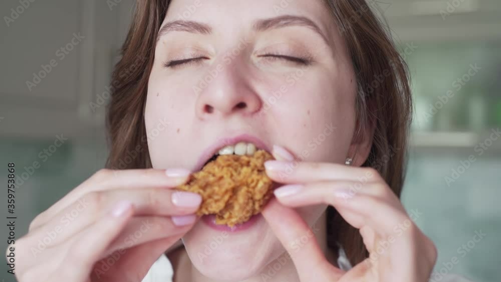 Unhealthy overeating. A woman bites chicken nuggets, close-up. Junk food Unhealthy overeating. A woman bites chicken nuggets, close-up. Junk food