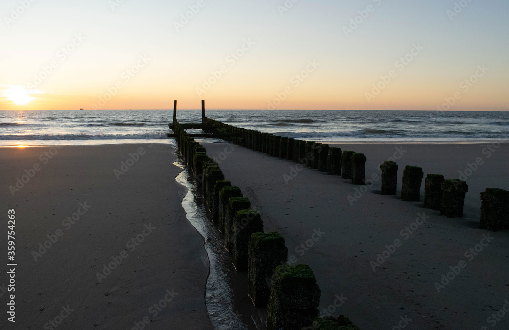 sunset at the beach, blue hour, breakwaters