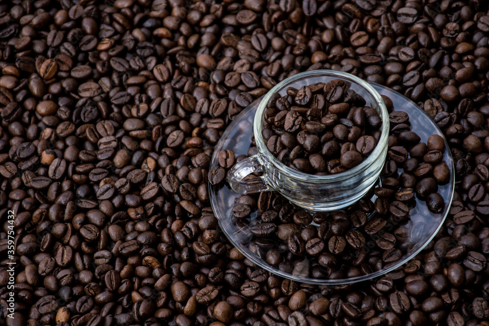 coffee beans in a cup and around the cup coffee beans in a cup and around the cup